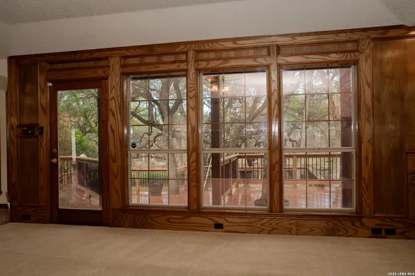 a view of staircase with lots of frames on wall and wooden floor