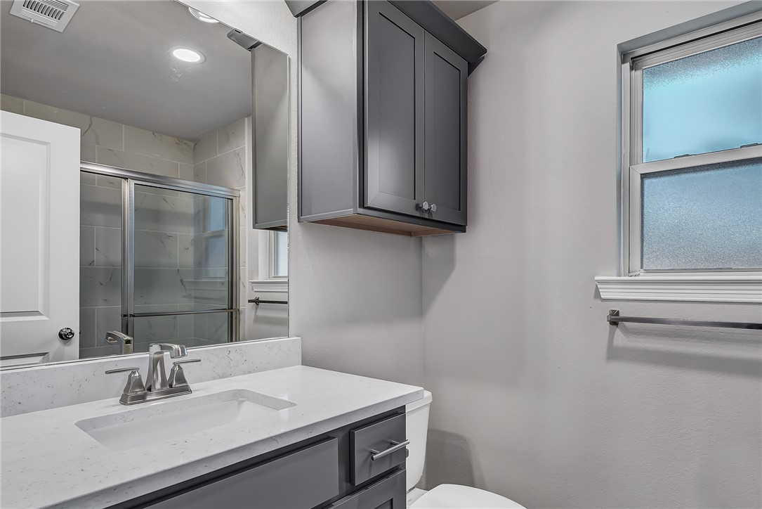 1231 High Street Navasota, TX 77868 - Photo 11 of 18 a bathroom with a sink toilet vanity and mirror