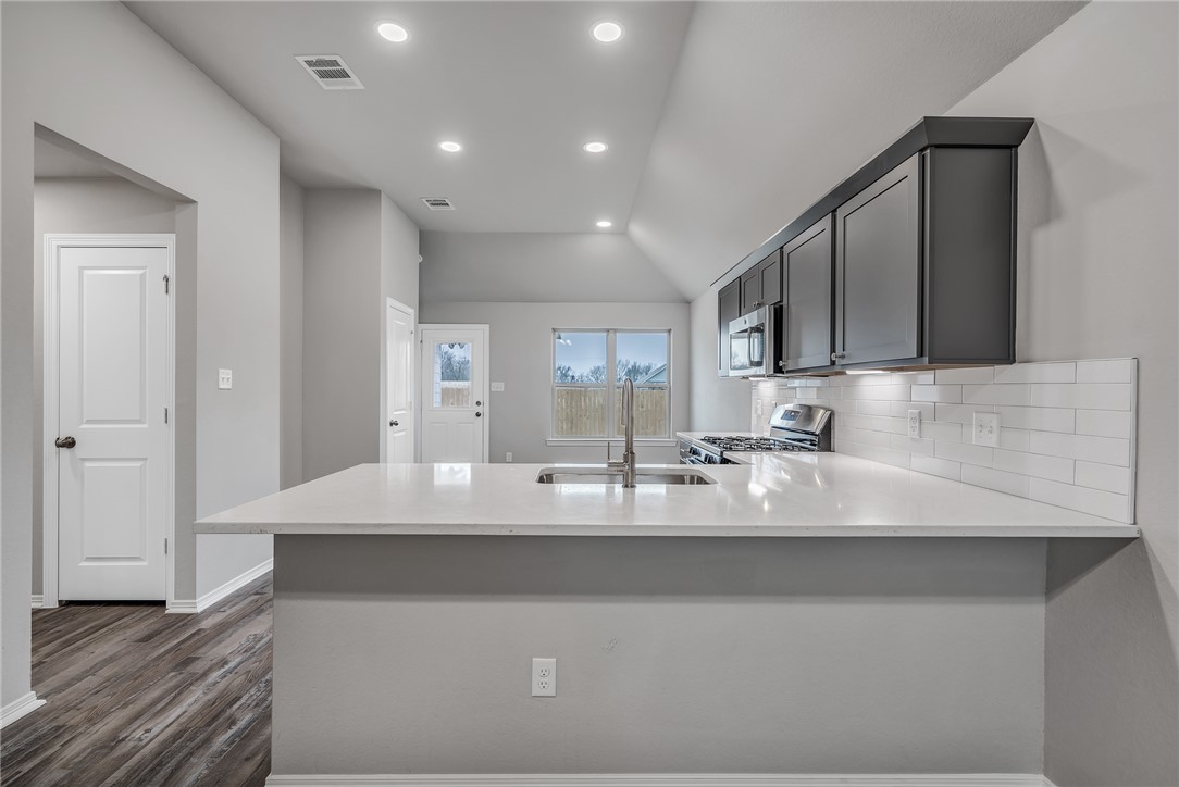 1231 High Street Navasota, TX 77868 - Photo 5 of 18 a large kitchen with granite countertop a sink and cabinets