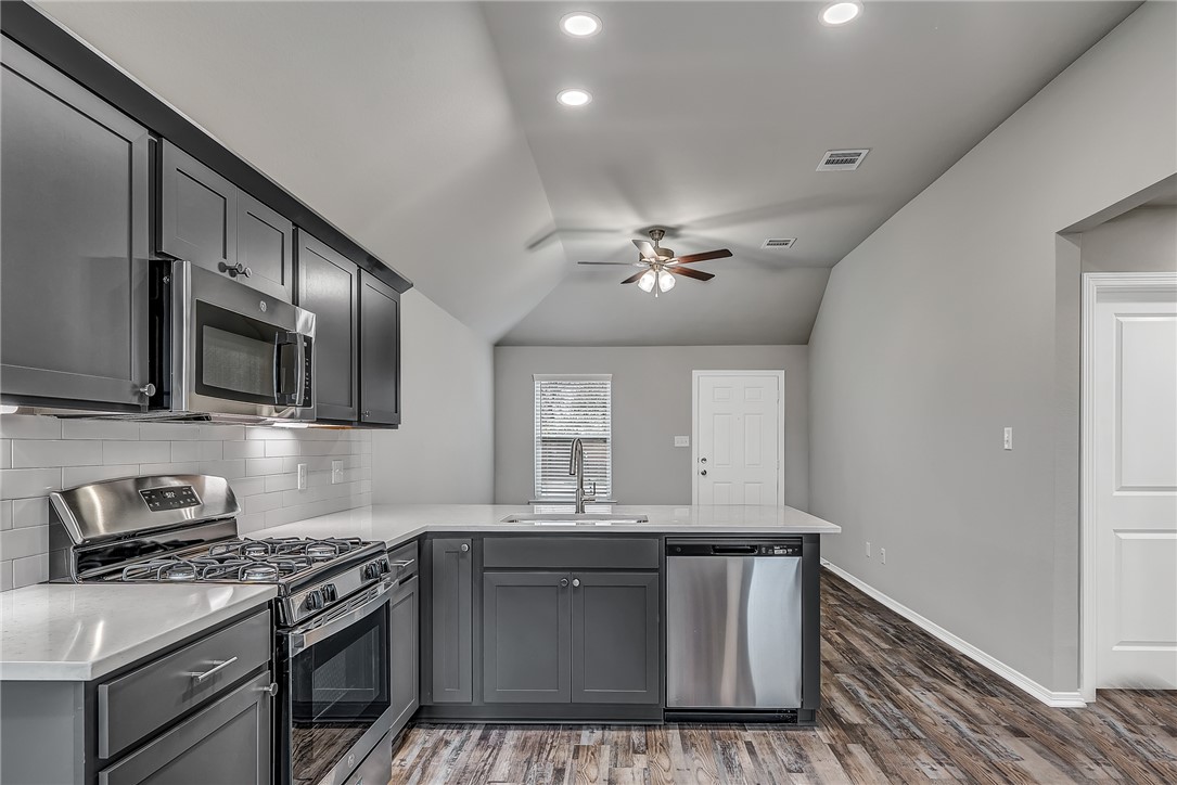 1231 High Street Navasota, TX 77868 - Photo 7 of 18 a kitchen with stainless steel appliances granite countertop a sink and stove top oven
