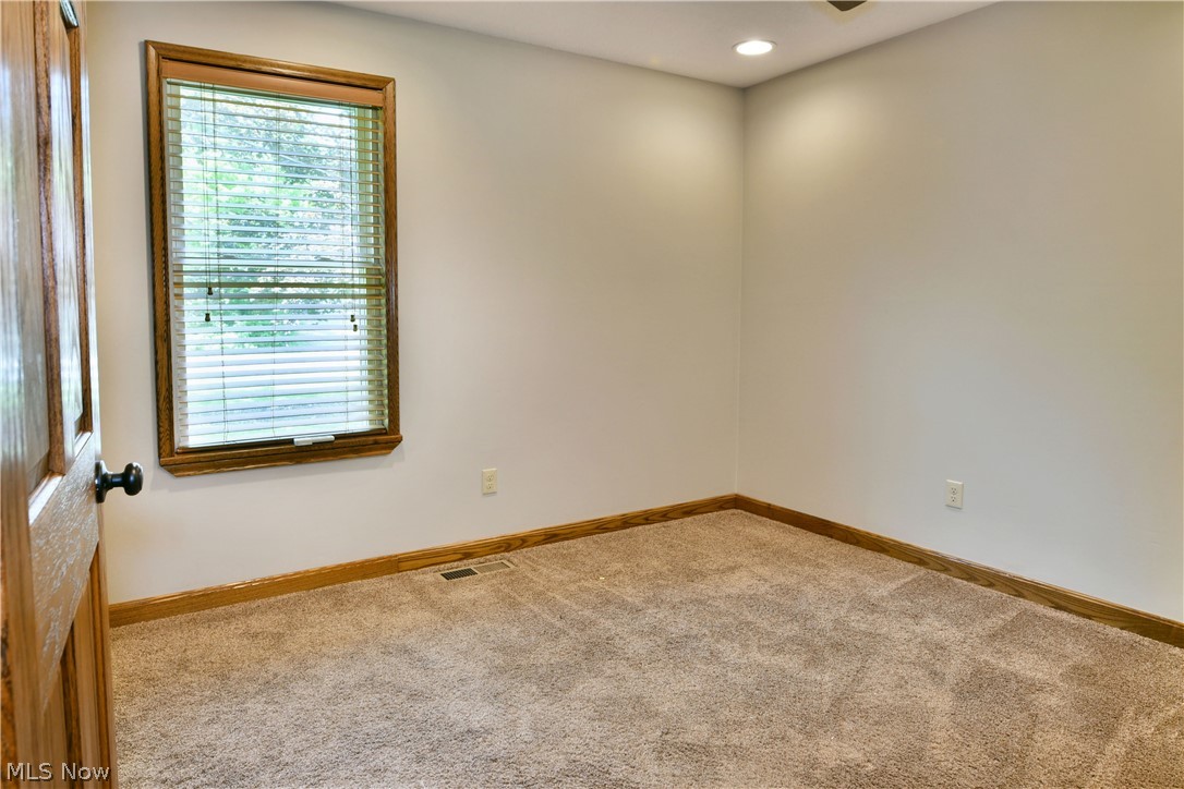 754 Warner Road Hubbard, OH 44425 - Photo 25 of 46 Carpeted room featuring a single window with wood trim, wood baseboards, and an overhead recessed light