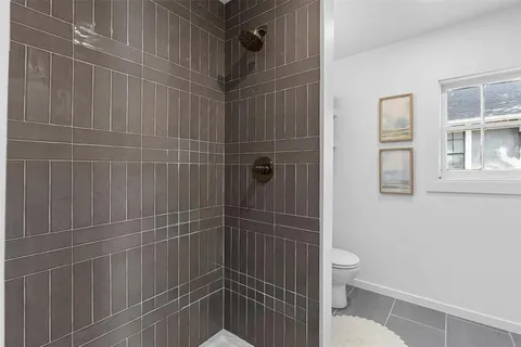 a bathroom with a toilet and shower