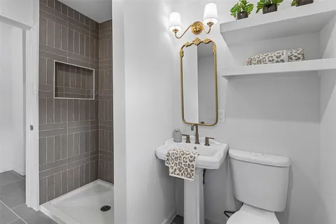 a bathroom with a sink toilet and shower