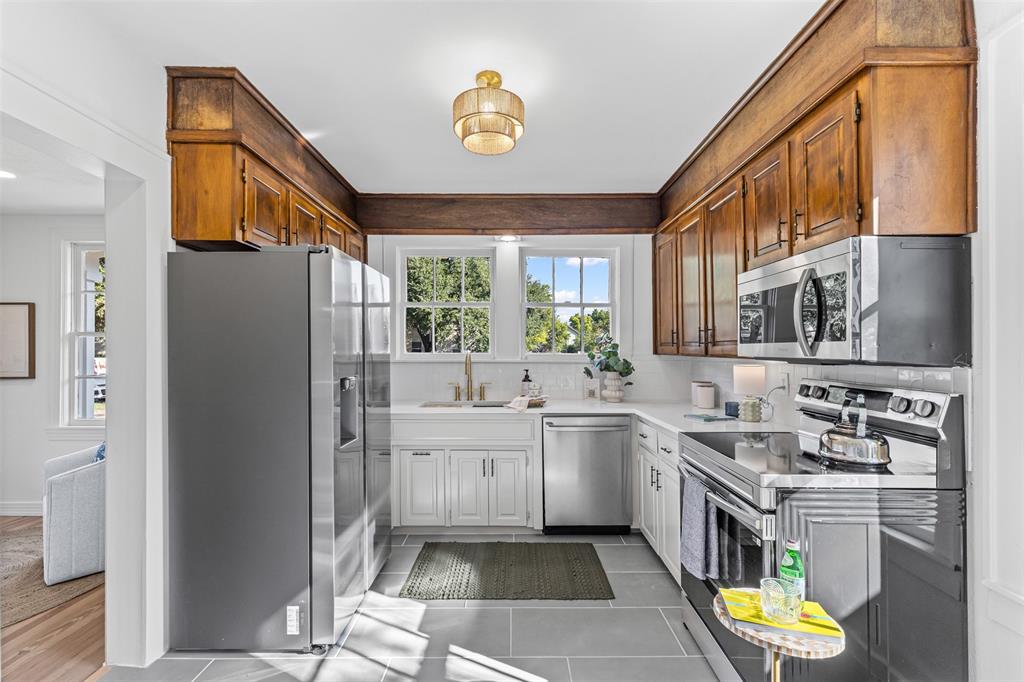 4723 El Campo Avenue Fort Worth, TX 76107 - Photo 7 of 21 a kitchen with stainless steel appliances granite countertop a sink and a refrigerator