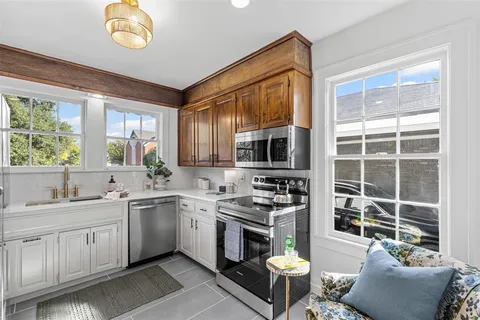 a kitchen with a sink stove and microwave