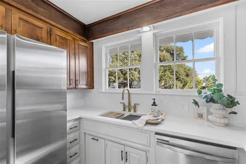 a bathroom with a granite countertop sink a mirror and a shower