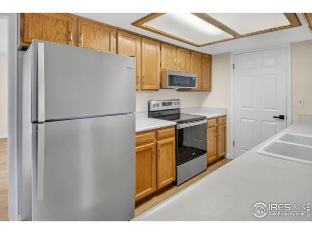 a kitchen with stainless steel appliances a refrigerator stove and microwave