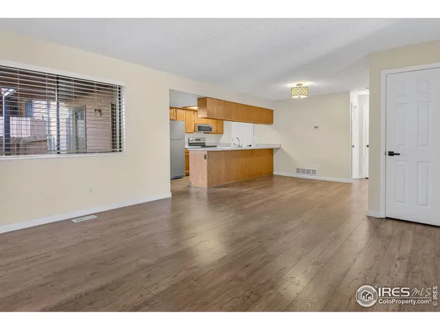 a view of a room with wooden floor and cabinet