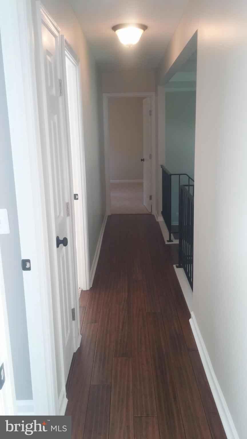 564 Sunset Knoll Road Pasadena, MD 21122 - Photo 14 of 29 a view of a hallway with wooden floor