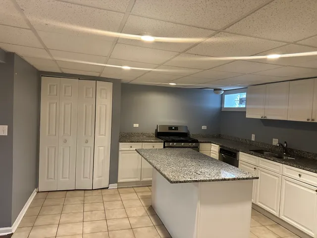 a kitchen with a stove a sink and a refrigerator