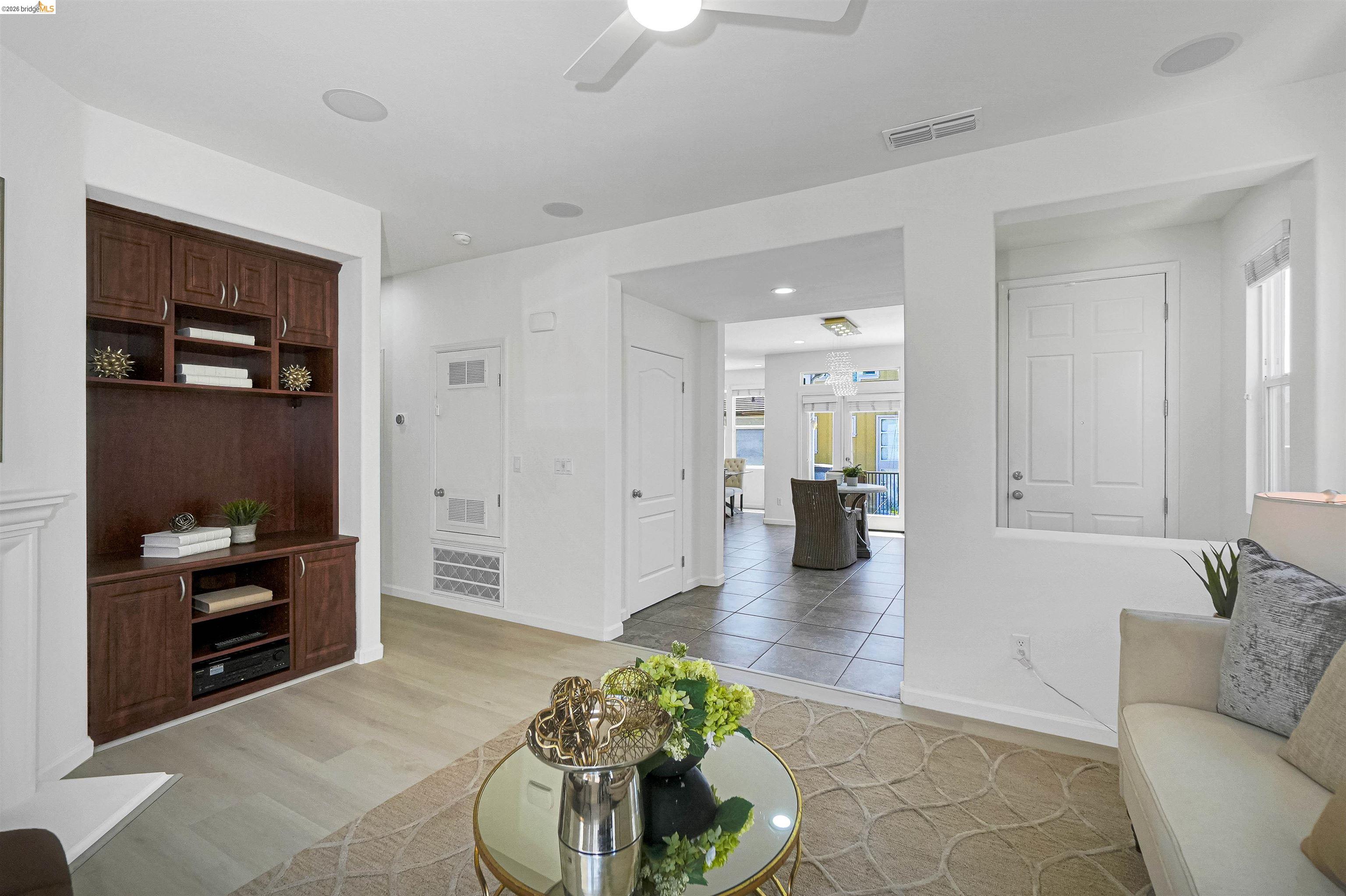 449 Constantine Court San Ramon, CA 94583 - Photo 16 of 63 Living area featuring wood-finish flooring, a built-in entertainment center, and a ceiling fan