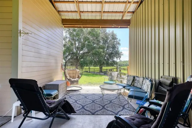 a view of a patio with couple of chairs