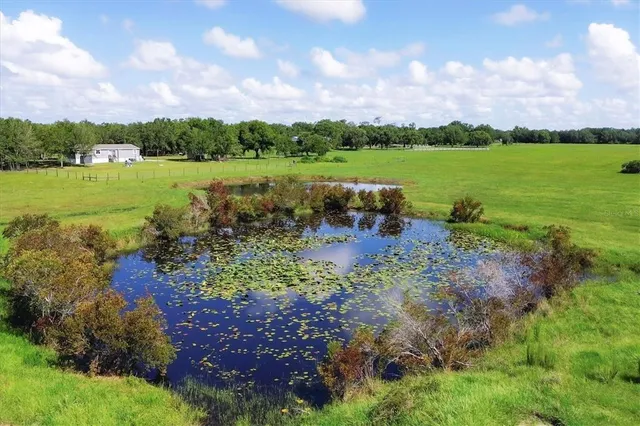 a view of a lake with houses in the back