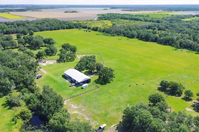 an aerial view of a houses with a yard