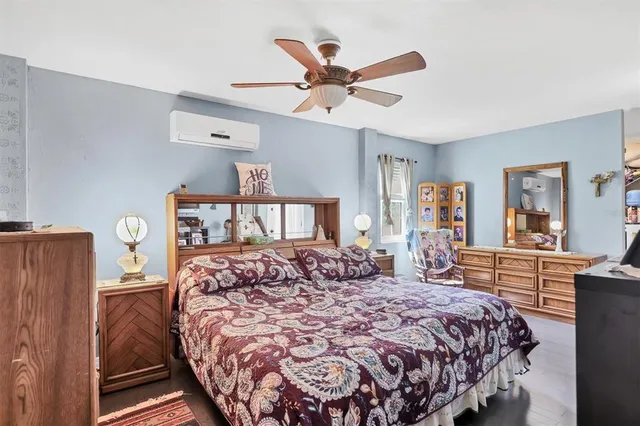 a bedroom with a large bed and a chandelier