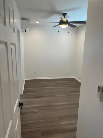 a view of a room with wooden floor and staircase