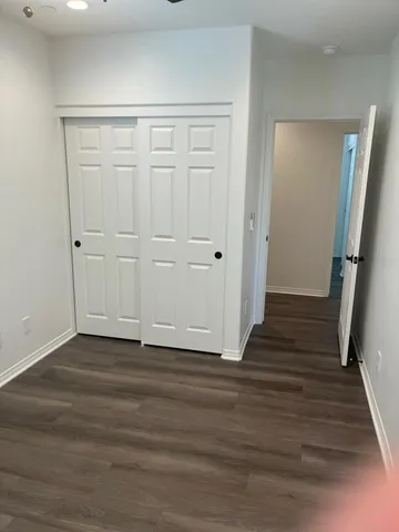 a view of a hallway with wooden floor