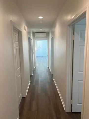 a view of a hallway with wooden floor