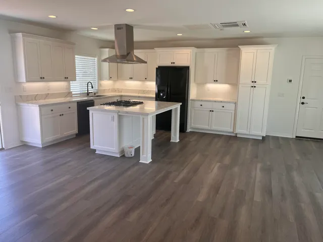 a kitchen with a sink stainless steel appliances and cabinets