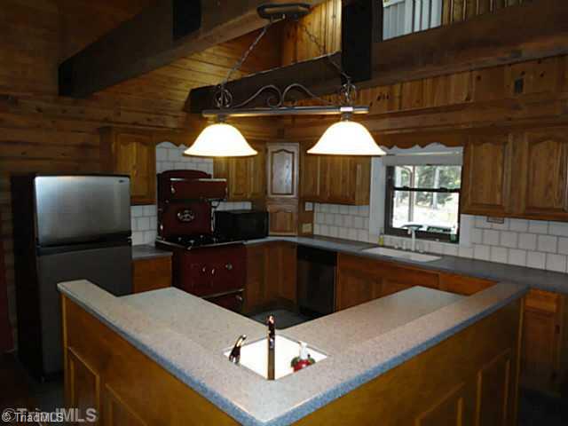 1136 Peabody Road Colfax, NC 27235 - Photo 3 of 16 Kitchen. Nicely updated kitchen - L-shaped island with prep sink