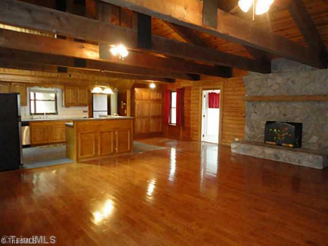 1136 Peabody Road Colfax, NC 27235 - Photo 5 of 16 Living Room. Kitchen, breakfast room and stone fireplace