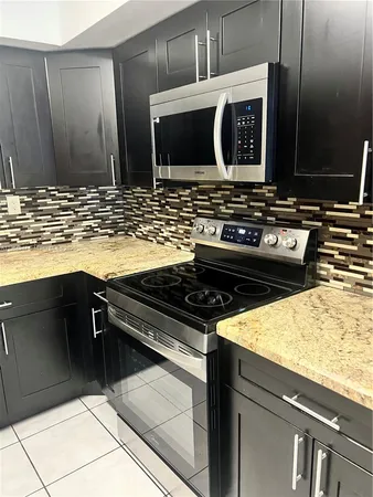 a kitchen with stainless steel appliances and cabinets