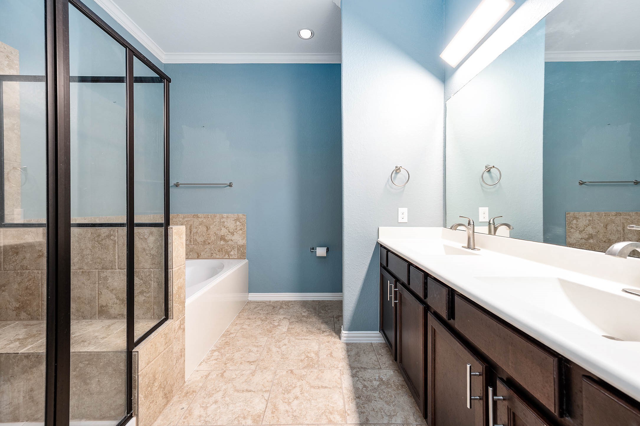 3050 Coreopsis Court Dickinson, TX 77539 - Photo 29 of 31 a spacious bathroom with a double vanity sink a mirror and a shower