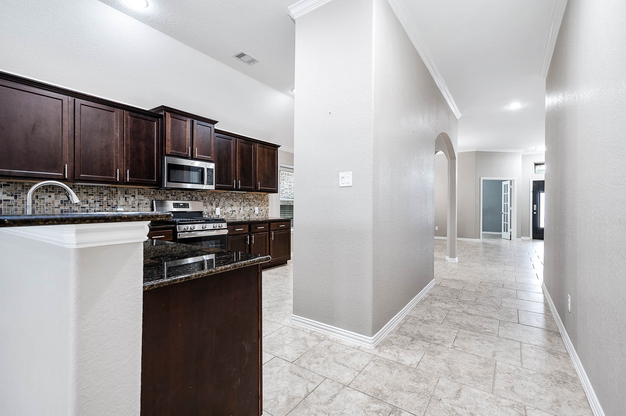 3050 Coreopsis Court Dickinson, TX 77539 - Photo 4 of 31 a kitchen with kitchen island a sink appliances and cabinets