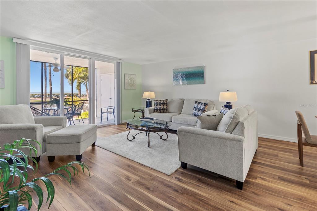 723 Bayport Way, Unit 723 Longboat Key, FL 34228 - Photo 15 of 67 a living room with furniture and wooden floor
