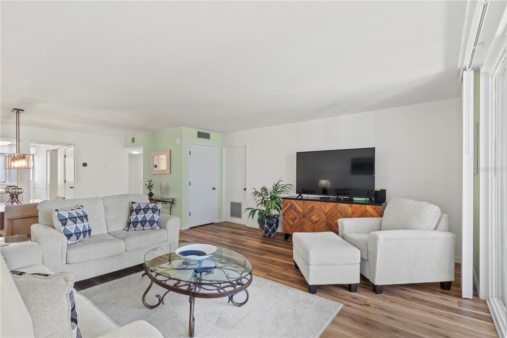 723 Bayport Way, Unit 723 Longboat Key, FL 34228 - Photo 17 of 67 a living room with furniture and a flat screen tv