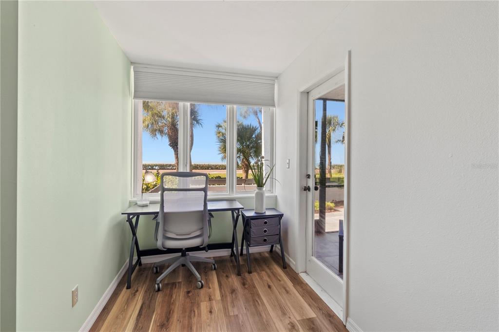 723 Bayport Way, Unit 723 Longboat Key, FL 34228 - Photo 21 of 67 a living room with a rug and a table