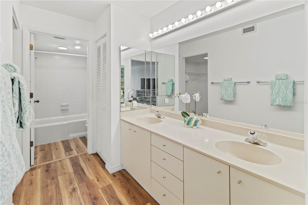 723 Bayport Way, Unit 723 Longboat Key, FL 34228 - Photo 22 of 67 a bathroom with a sink double vanity granite tub shower and a mirror