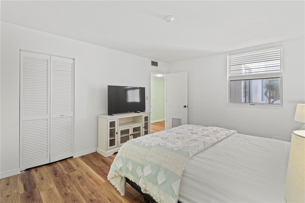 723 Bayport Way, Unit 723 Longboat Key, FL 34228 - Photo 26 of 67 a bedroom with a bed and a flat screen tv