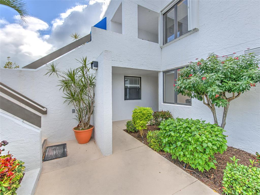 723 Bayport Way, Unit 723 Longboat Key, FL 34228 - Photo 3 of 67 a potted plant sitting in front of a house