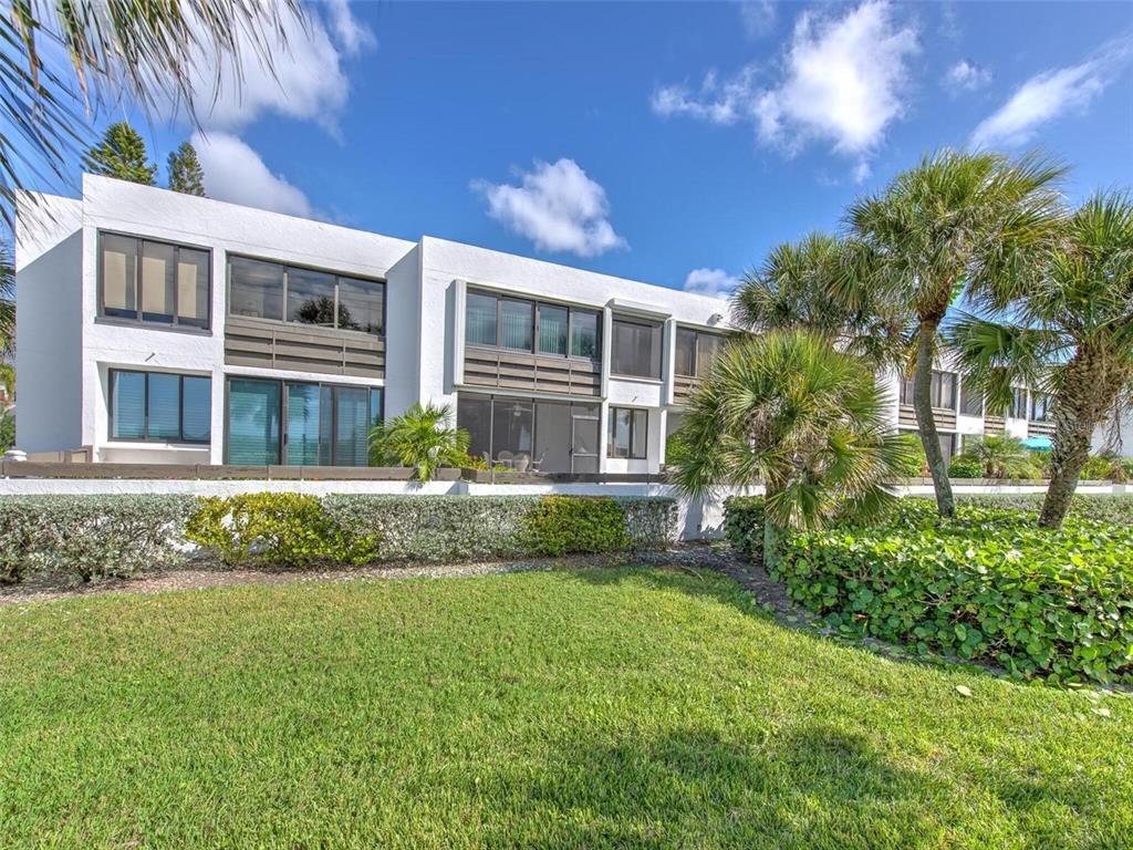 723 Bayport Way, Unit 723 Longboat Key, FL 34228 - Photo 34 of 67 a front view of a house with a yard