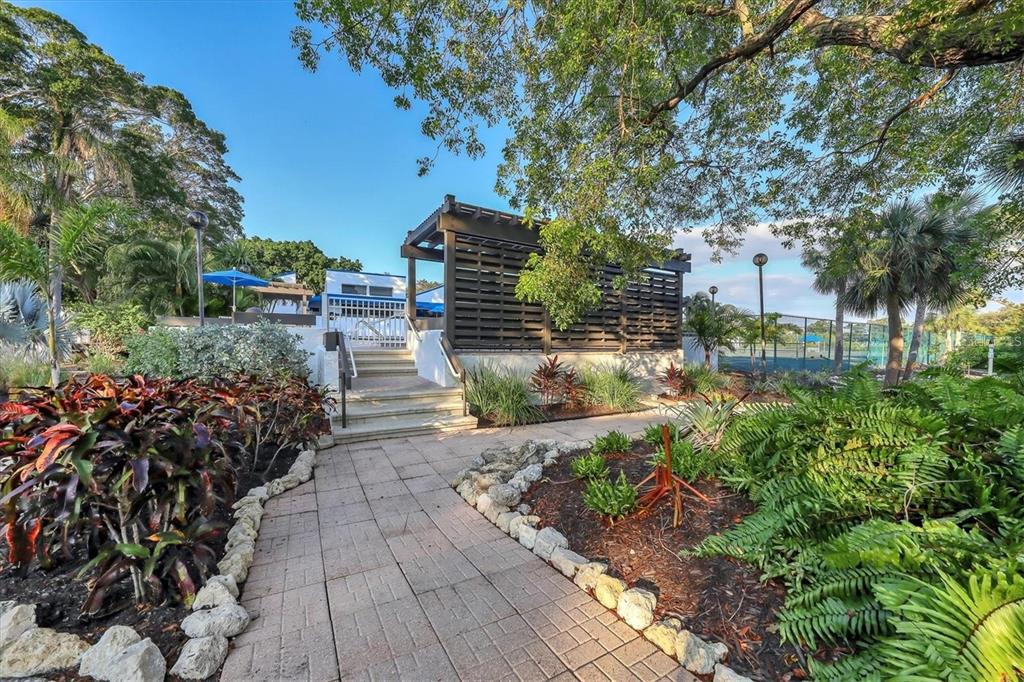 723 Bayport Way, Unit 723 Longboat Key, FL 34228 - Photo 54 of 67 a view of a pathway with a flower garden