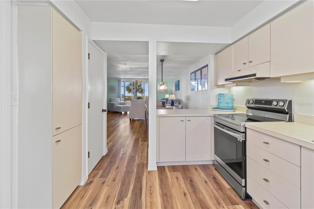723 Bayport Way, Unit 723 Longboat Key, FL 34228 - Photo 9 of 67 a kitchen with white cabinets and appliances
