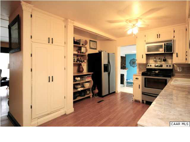 8607 3 Notch Road Louisa, VA 23093 - Photo 11 of 26 a kitchen with stainless steel appliances a refrigerator and a stove top oven