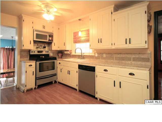 8607 3 Notch Road Louisa, VA 23093 - Photo 12 of 26 a kitchen with granite countertop a sink stainless steel appliances and cabinets