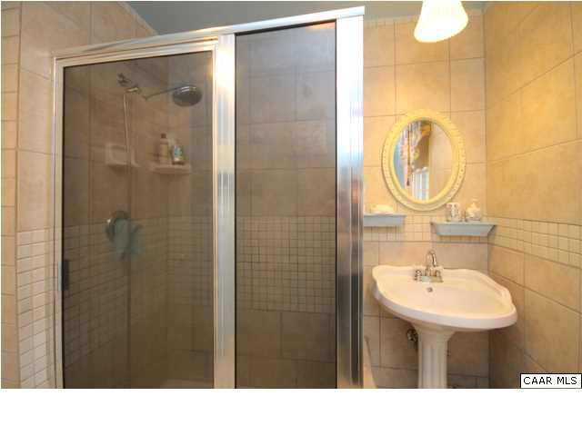 8607 3 Notch Road Louisa, VA 23093 - Photo 19 of 26 a bathroom with a sink a shower and a mirror