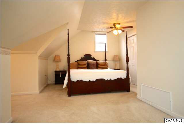 8607 3 Notch Road Louisa, VA 23093 - Photo 21 of 26 a living room with a bed furniture and a large mirror