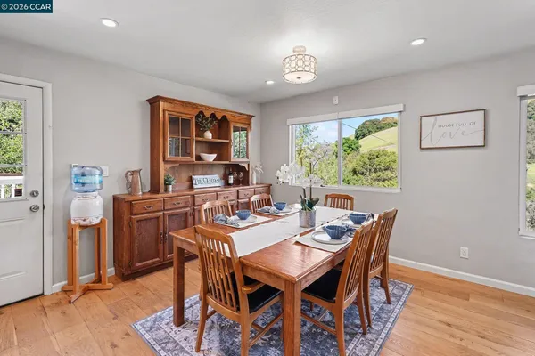 a view of a dining room with furniture window and wooden floor