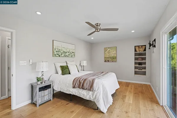 a bedroom with a large bed and a chandelier