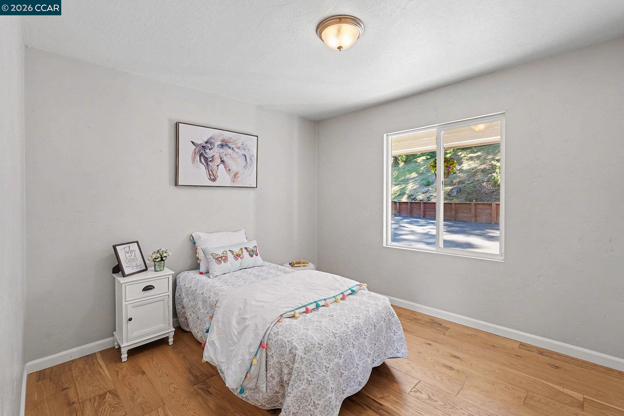5745 Alhambra Valley Road Martinez, CA 94553 - Photo 25 of 47 a bedroom with a bed and wooden floor