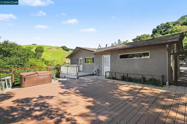 a view of a house with backyard and sitting area