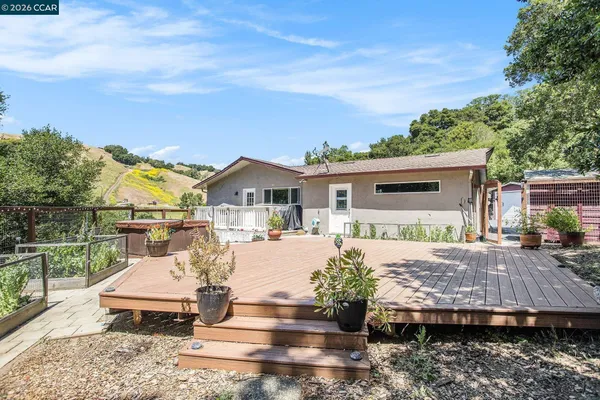 a view of a house with backyard and sitting area