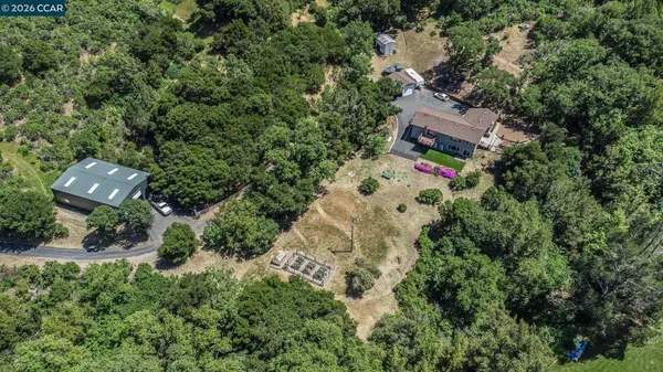 an aerial view of a house with a yard