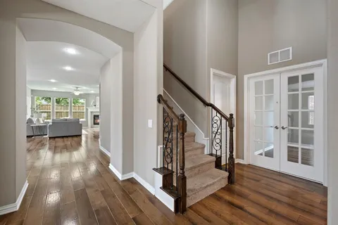 a view of a hallway view with wooden floor and staircase
