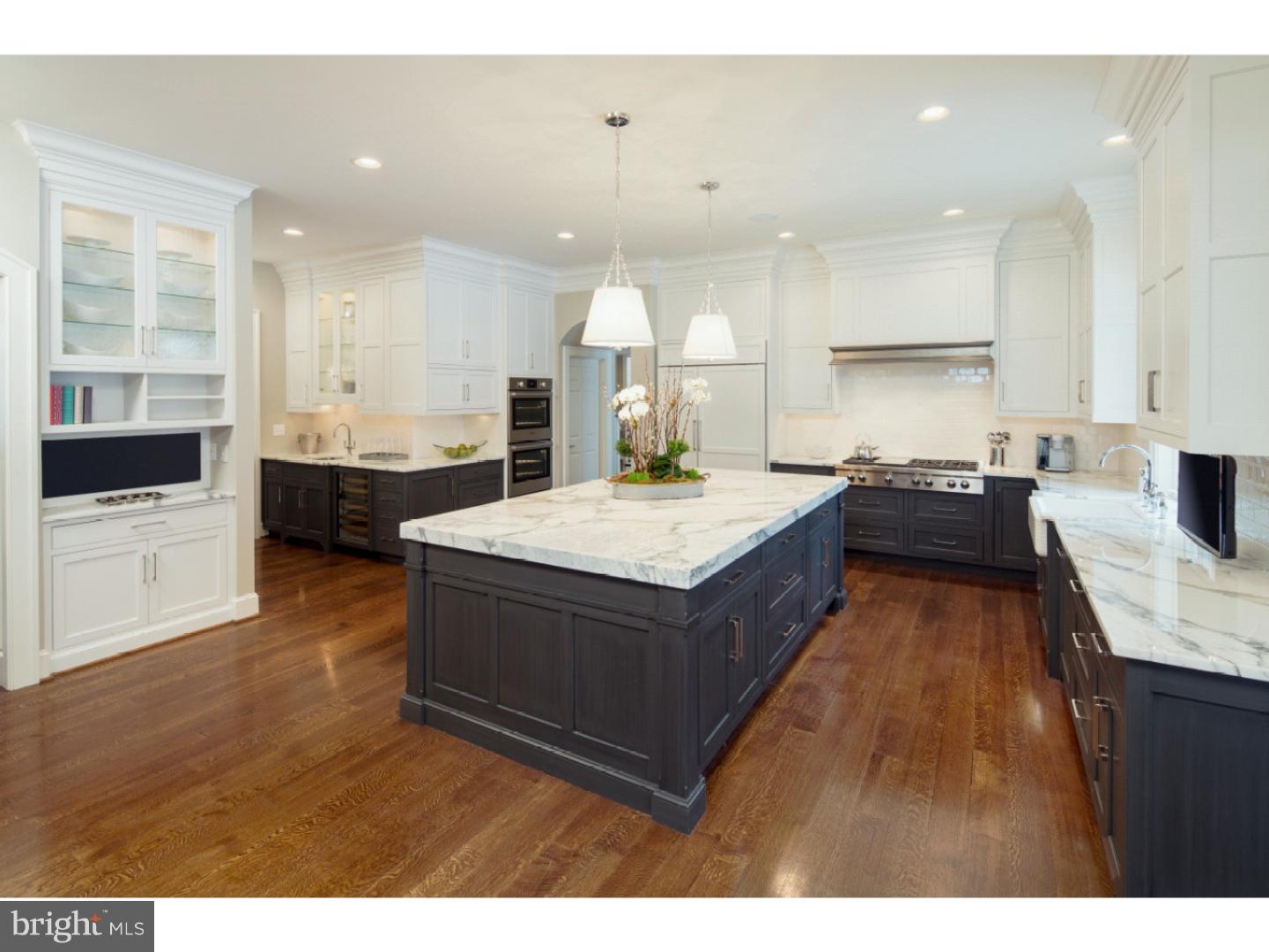 220 South Waterloo Road Devon, PA 19333 - Photo 8 of 13 a living room with stainless steel appliances kitchen island granite countertop a refrigerator a sink dishwasher and a stove with wooden floor