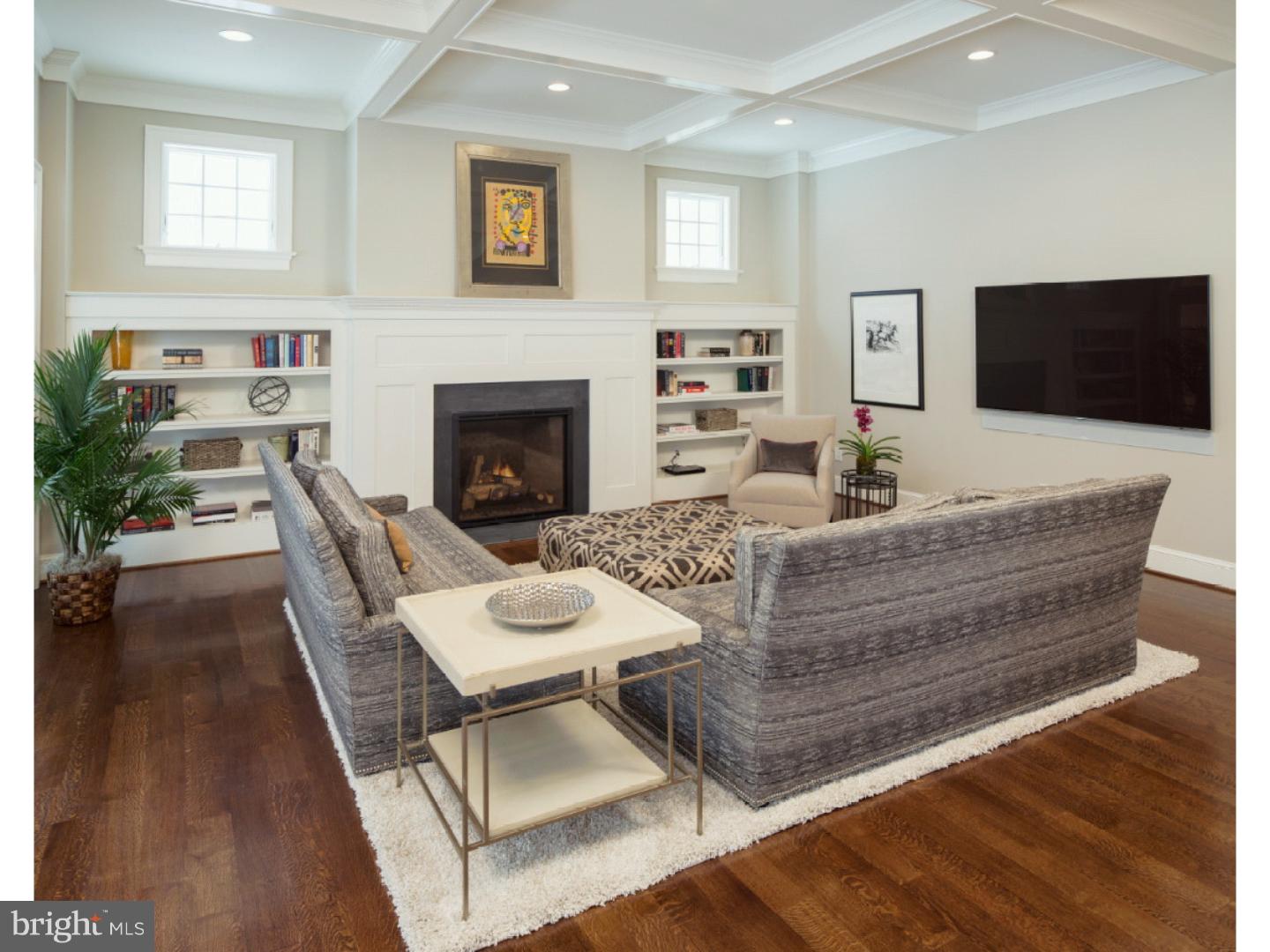 220 South Waterloo Road Devon, PA 19333 - Photo 9 of 13 a living room with furniture a flat screen tv and a fireplace